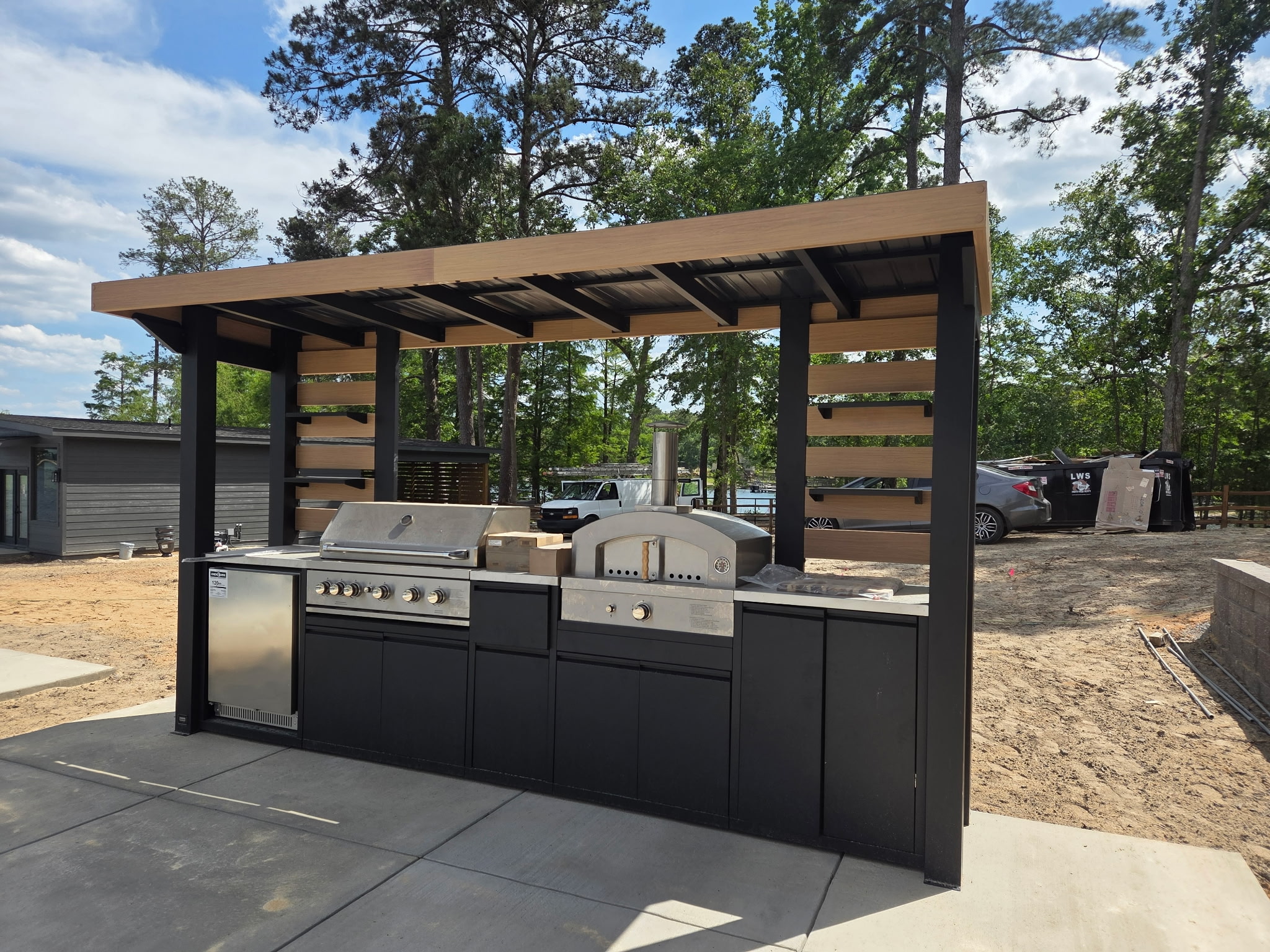 Custom outdoor kitchen with grill and pergola structure